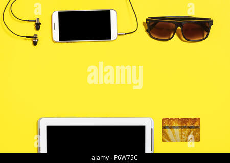 collection of gadgets and accessories on a yellow background Stock Photo