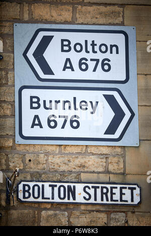 Highways road signs Bolton A676, and Burnley on  Bridge Street, Bolton street junction , Ramsbottom village, Lancashire. Stock Photo