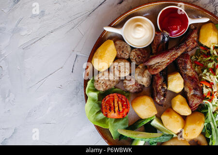 Top photo of clay plate full of tasty appetizers for beer. Stock Photo