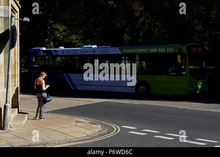 Woman on pavement, Hebden Bridge, Calderdale, West Yorkshire, England UK Stock Photo