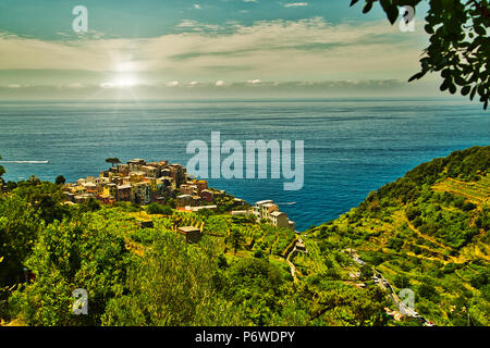 colorful houses overlooking deep blue sea in Italy Stock Photo