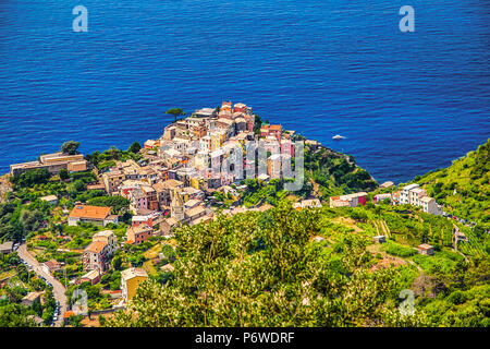 colorful houses overlooking deep blue sea in Italy Stock Photo