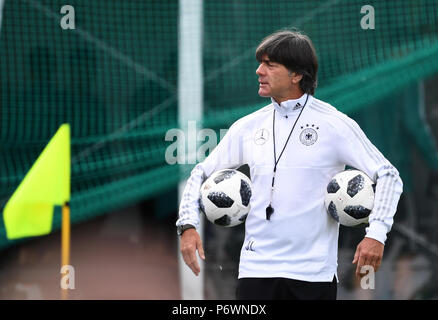 FILED - 14 June 2018, Russia, Watutinki: Soccer, World Cup 2018, German national team, team quarters. Head coach Joachim Loew holding two balls during training. According to information from the Newspaper 'Bild' and 'Sport Bild', Loew is going to carry on as coach despite the team going out of the world cup at the group stages. Both media outlets reported the new on Tuesdaym 03 July 2018. Photo: Ina Fassbender/dpa Stock Photo
