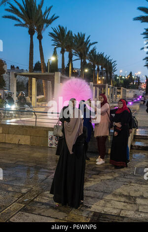 Jerusalem, Israel. 2nd July, 2018. A group of Muslim women take a photo near a light sculpture during the 2018 Festival of lights. This is the 10th anniversary of the festival, festival, israel, jerusalem, Jerusalem. The Festival of Lights in the Old city, jewish, which draws hundreds of thousands of visitors to the old city of Jerusalem, which is lit by many light sculptures and shows Credit: Yagil Henkin/Alamy Live News Stock Photo