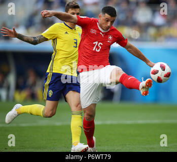 Saint Petersburg, Russia. 3rd July, 2018. Blerim Dzemaili (R) of Switzerland vies with Victor Lindelof of Sweden during the 2018 FIFA World Cup round of 16 match between Switzerland and Sweden in Saint Petersburg, Russia, July 3, 2018. Credit: Wu Zhuang/Xinhua/Alamy Live News Stock Photo