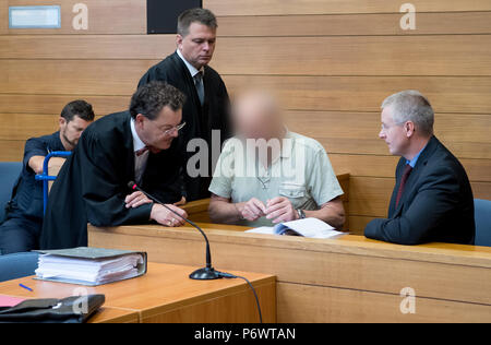 Germany, Traunstein. 03rd July, 2018. The 63 year old defendant who is charged for 2 murders (2nd from the right) sits before the hearing with an interpreter (r) and his attorneys Michael Vogel (2nd from the left) and Walter Appel (3rd from the left) is in the court room of the City court. The man is said to have killed two men in a pub in September 2017 and seriously injured the landlady and her acquaintances. (Attention: the defendant was defaced as requested by his lawyers.) Credit: Sven Hoppe/dpa - ATTENTION: individual(s) has/have been pixelated for legal reasons/dpa/Alamy Live News Stock Photo