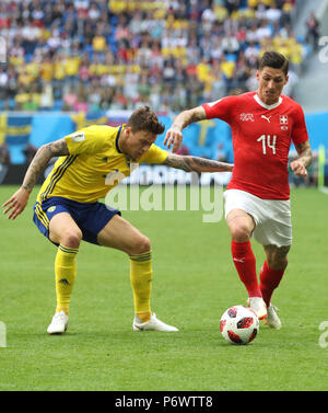 Saint Petersburg, Russia. 3rd July, 2018. Steven Zuber (R) of Switzerland vies with Victor Lindelof of Sweden during the 2018 FIFA World Cup round of 16 match between Switzerland and Sweden in Saint Petersburg, Russia, July 3, 2018. Credit: Cao Can/Xinhua/Alamy Live News Stock Photo