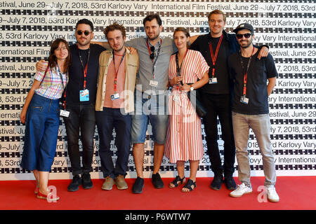 Karlovy Vary, Czech Republic. 03rd July, 2018. From left: co-producer Darina Maslona, producer Jan Kwiecinski, Polish director Pawel Maslona, screenwriter and actor Bartlomiej Kotschedoff, screenwriter and actress Aleksandra Pisula, director of photography Cezary Stolecki and Pisula's fiancee Lukas Gewalt pose in front of a photo wall at a news conference to Maslona's film Panic Attack during the 53d International Film Festival in Karlovy Vary (KVIFF), Czech Republic, on July 3, 2018. Credit: Slavomir Kubes/CTK Photo/Alamy Live News Stock Photo