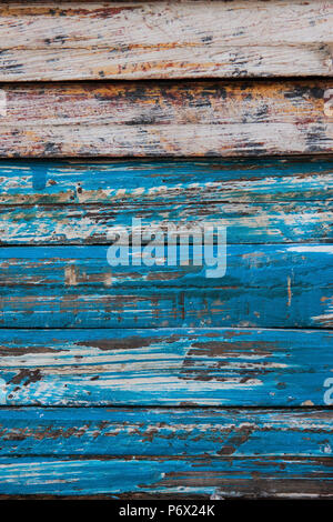 Vertical image of weathered wooden planks with chipped and scraped blue paint Stock Photo