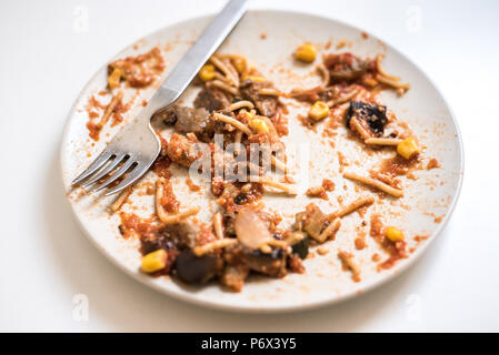 Dish of noddles finished dirty and empty ready to throw away Stock Photo