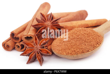 Some aromatic cinnamon with star anise and ground spice in a wooden spoon Stock Photo