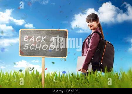 Pretty asian student ready back to school with blue sky background Stock Photo