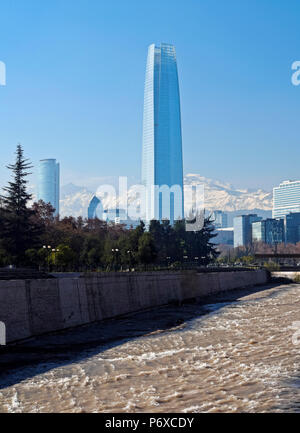 Chile, Santiago, View over Mapocho River towards the high raised buildings with Costanera Center Tower, the tallest building in South America. Snow covered Andes in the background. Stock Photo