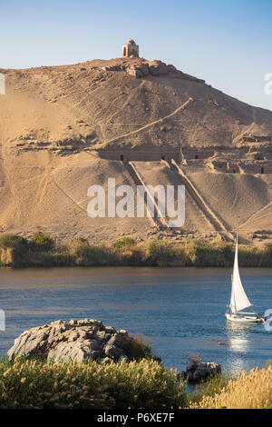 Egypt, Upper Egypt, Aswan, Elephantine Island, View of river Nile and Tombs of the Nobles on the West Bank from the gardens of the Movenpick Resort Stock Photo