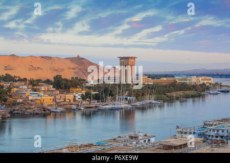 Egypt, Upper Egypt, Aswan, View of River Nile looking towards the Movenpick Resort and Tombs of the Nobles Stock Photo