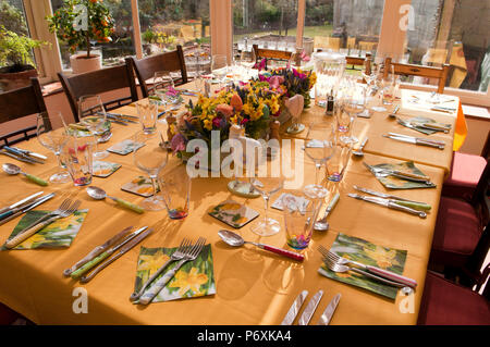 Dining table laid with beautiful spring flowers and Easter decorations Stock Photo
