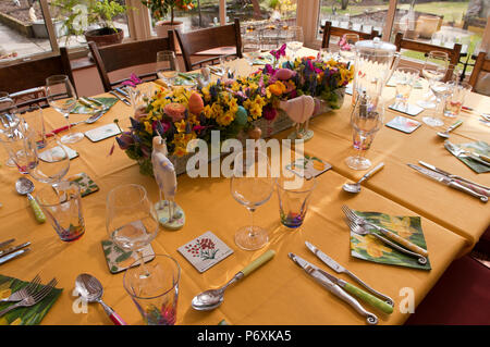 Dining table laid with beautiful spring flowers and Easter decorations Stock Photo