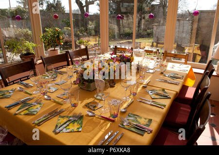 Dining table laid with beautiful spring flowers and Easter decorations Stock Photo