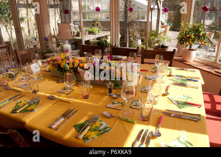 Dining table laid with beautiful spring flowers and Easter decorations Stock Photo