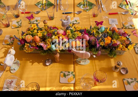 Dining table laid with beautiful spring flowers and Easter decorations Stock Photo