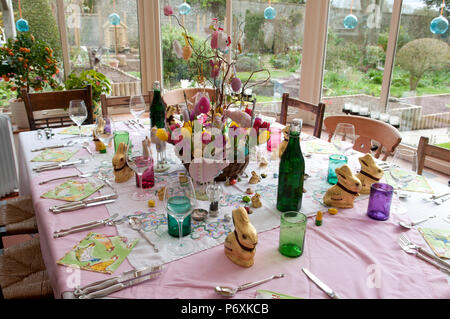 Dining table laid with beautiful spring flowers and Easter decorations Stock Photo