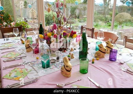 Dining table laid with beautiful spring flowers and Easter decorations Stock Photo