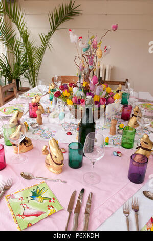 Dining table laid with beautiful spring flowers and Easter decorations Stock Photo