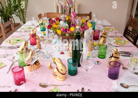 Dining table laid with beautiful spring flowers and Easter decorations Stock Photo