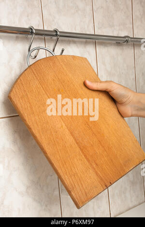 hand of woman with wooden cutting board Stock Photo