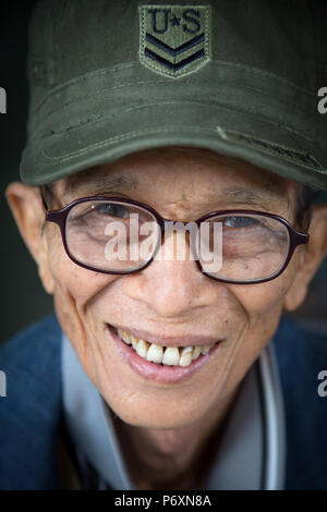 Portrait of smiling old man with USA cap in Saigon ,Vietnam Stock Photo