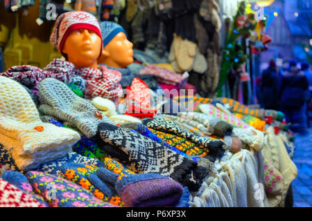 Woolen scarves and mittens with a national Latvian design in a stall at the Christmas Fair in Riga Stock Photo