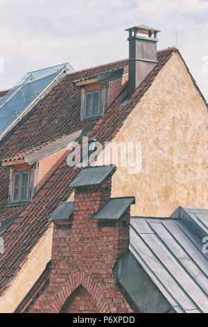 Red tiled roof on pointed houses with chimneys of the old city of Riga Stock Photo