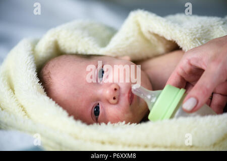 Newborn baby boy with plastik bottle closeup Stock Photo