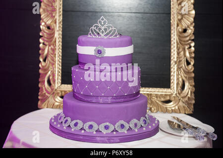 Sweet sixteen birthday cake on a cake stand with background a picture frame Stock Photo