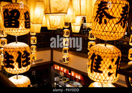 A yellow lantern hanging from the ceiling Stock Photo