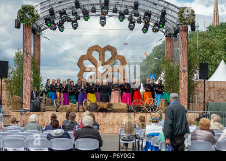 RIGA, LATVIA - JUNE 22, 2018: Summer solstice market. Women's ensemble performs at the market square. Stock Photo