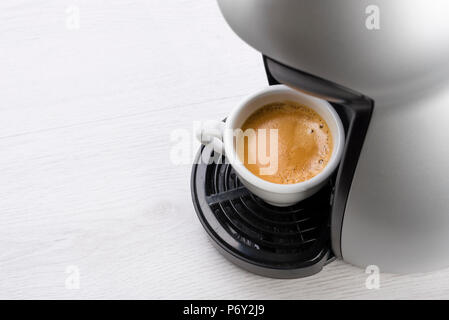 cup of coffee just filled on the machine Stock Photo