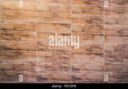 floor background and texture of decorative redwood stripe on wall / marble tiled floor / tile brown floor background. Stock Photo