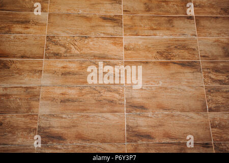 floor background and texture of decorative redwood stripe on wall / marble tiled floor / tile brown floor background / wooden floor background. Stock Photo