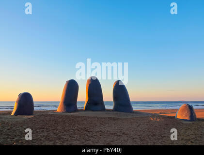 Uruguay, Maldonado Department, Punta del Este, Playa Brava, La Mano(The Hand), a sculpture by Chilean artist Mario Irarrazabal at sunrise. Stock Photo