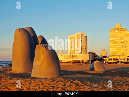 Uruguay, Maldonado Department, Punta del Este, Playa Brava, La Mano(The Hand), a sculpture by Chilean artist Mario Irarrazabal at sunrise. Stock Photo