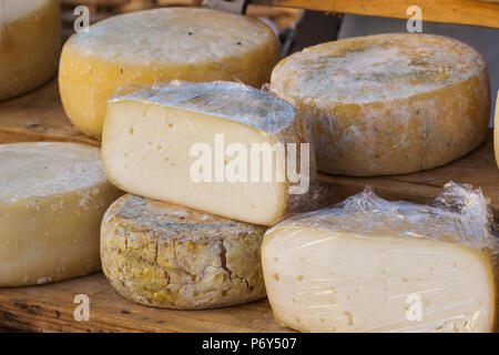 Different sorts of italian cheese produced from goat milk in market. Stock Photo
