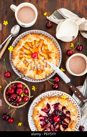 Rustic open pies with apricots and raspberry, top view Stock Photo
