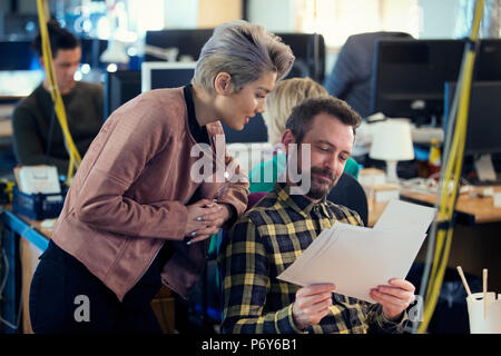 Creative business people discussing paperwork in office Stock Photo