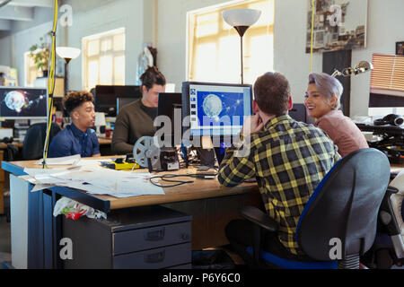 Creative business people working at computers in open plan office Stock Photo