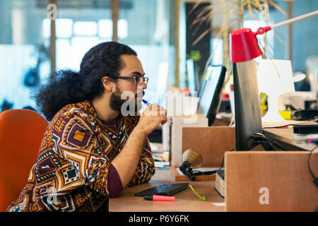 Focused creative businessman working at computer in office Stock Photo