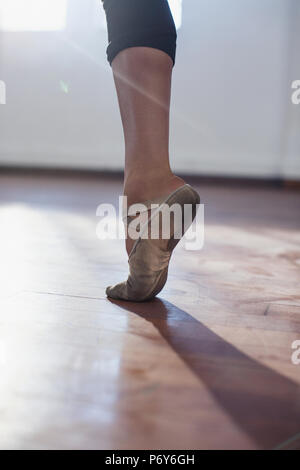 Close up young female ballet dancer practicing in ballet shoe Stock Photo