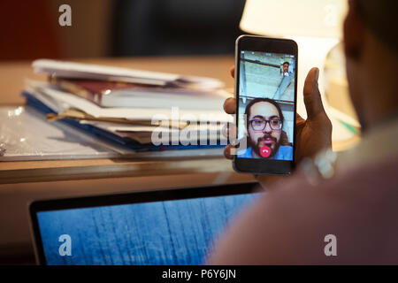 Businessman video chatting with colleague on smart phone Stock Photo