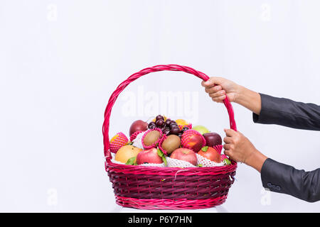 Group fruit in basket on white background, hand business holding basket fruit, Stock Photo