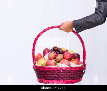 Group fruit in basket on white background, hand business holding basket fruit, Stock Photo